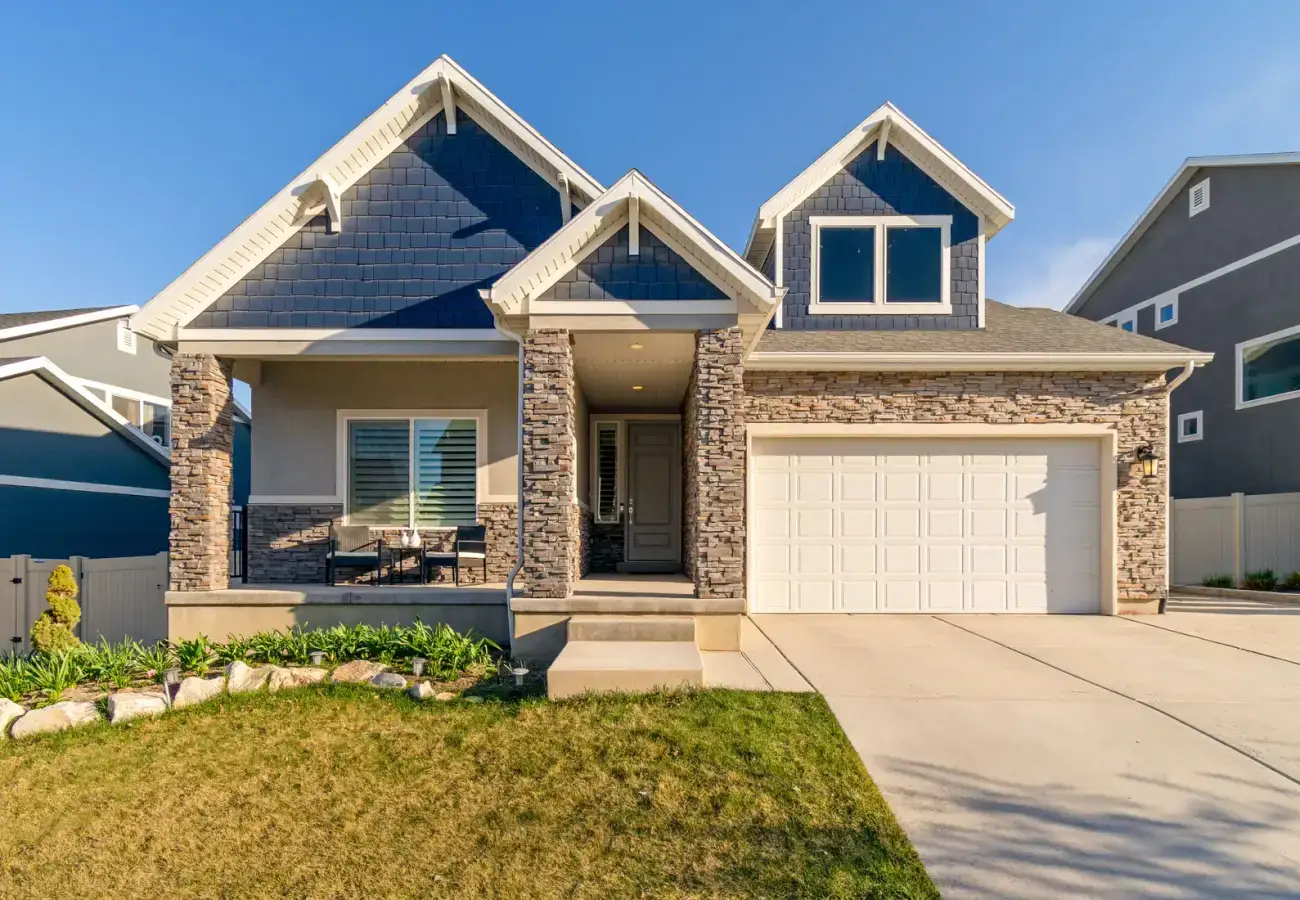 Suburban home with a stone facade and a maintained lawn